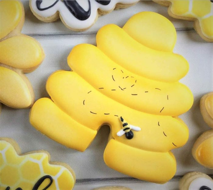 bee hive shaped cookie with yellow royal icing 