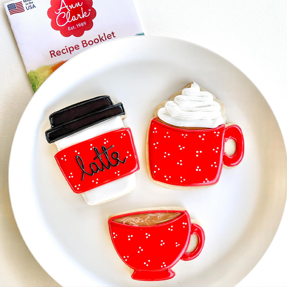 Image of teacup, travel mug, and cocoa mug sugar cookies decorated with red and white royal icing