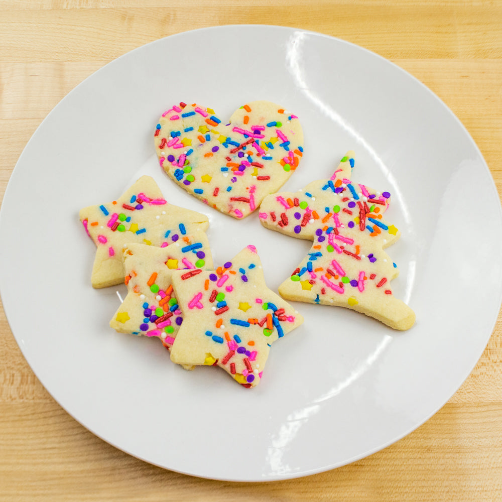 Sugar cookies on a plate, decorated with sprinkles