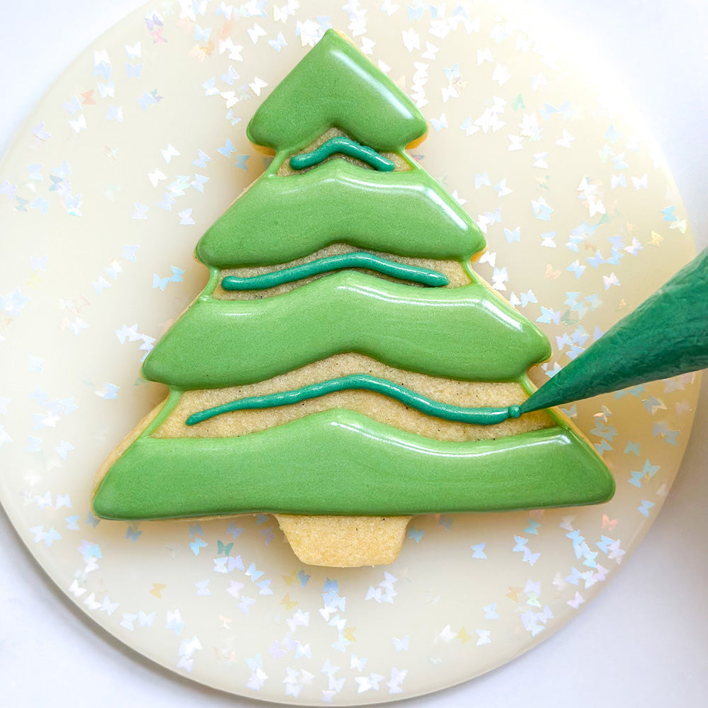 Evergreen tree cookie in alternating light green and teal icing