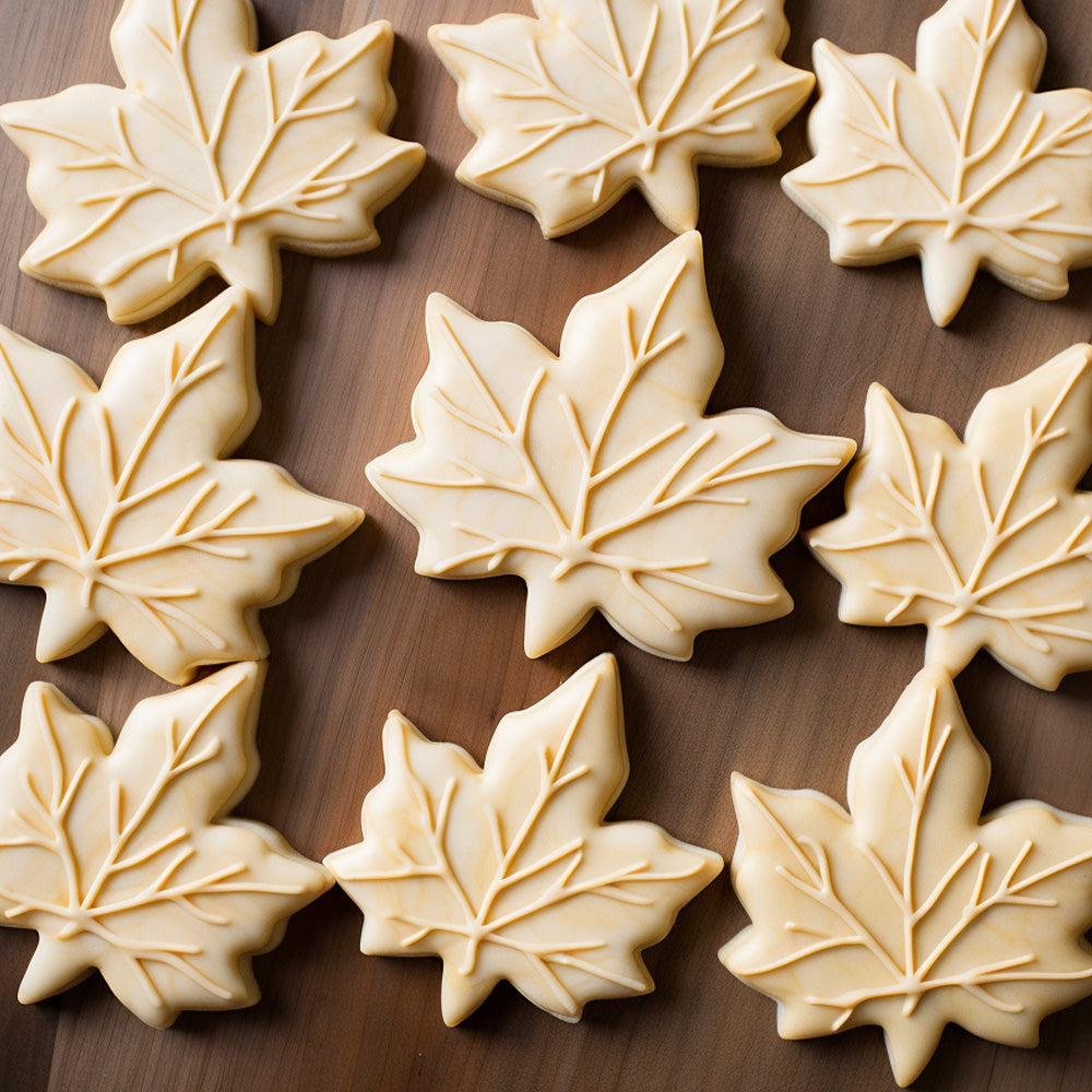 maple leaf shaped cookies with light tan icing