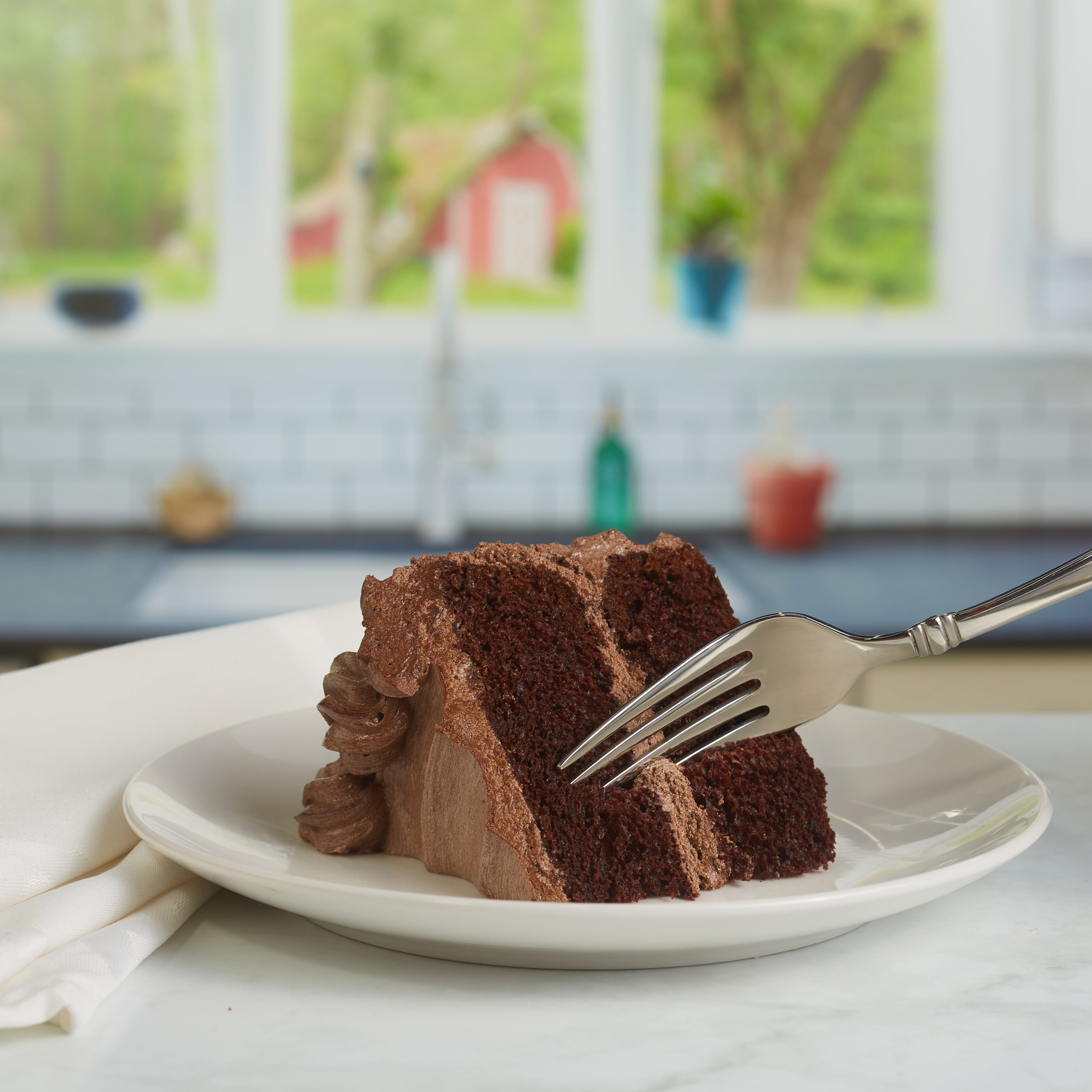 Image of a fork cutting into a chocolate cake slice