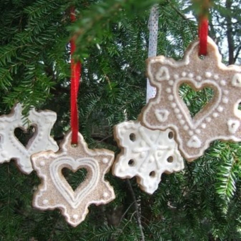 snowflake shaped cookies hanging from a tree branch