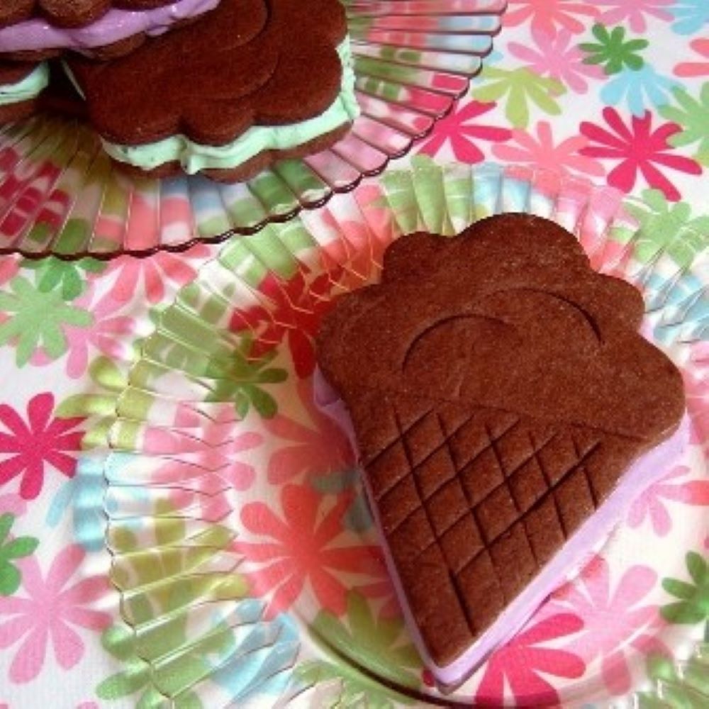 an ice cream sandwich in the shape of an ice cream cone on a floral tablecloth