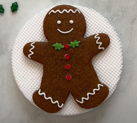 Traditional gingerbread man cookie on a white plate