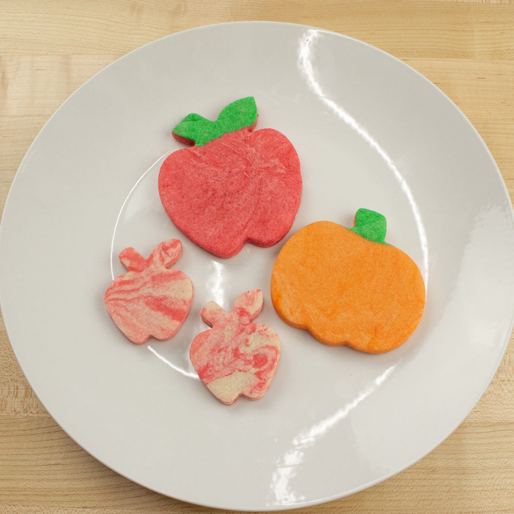 Apple and pumpkin sugar cookies dyed red and orange.