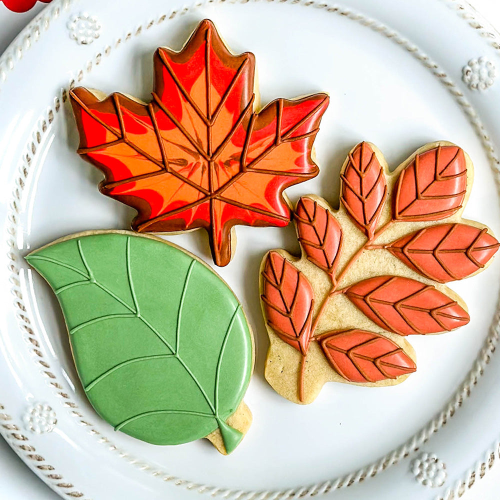 three leaf shaped cookies on a white plate