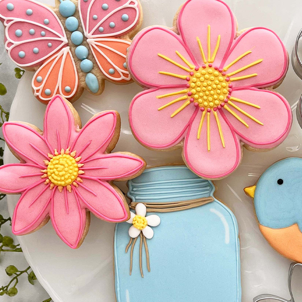 flower, butterfly, and mason jar cookies on a plate