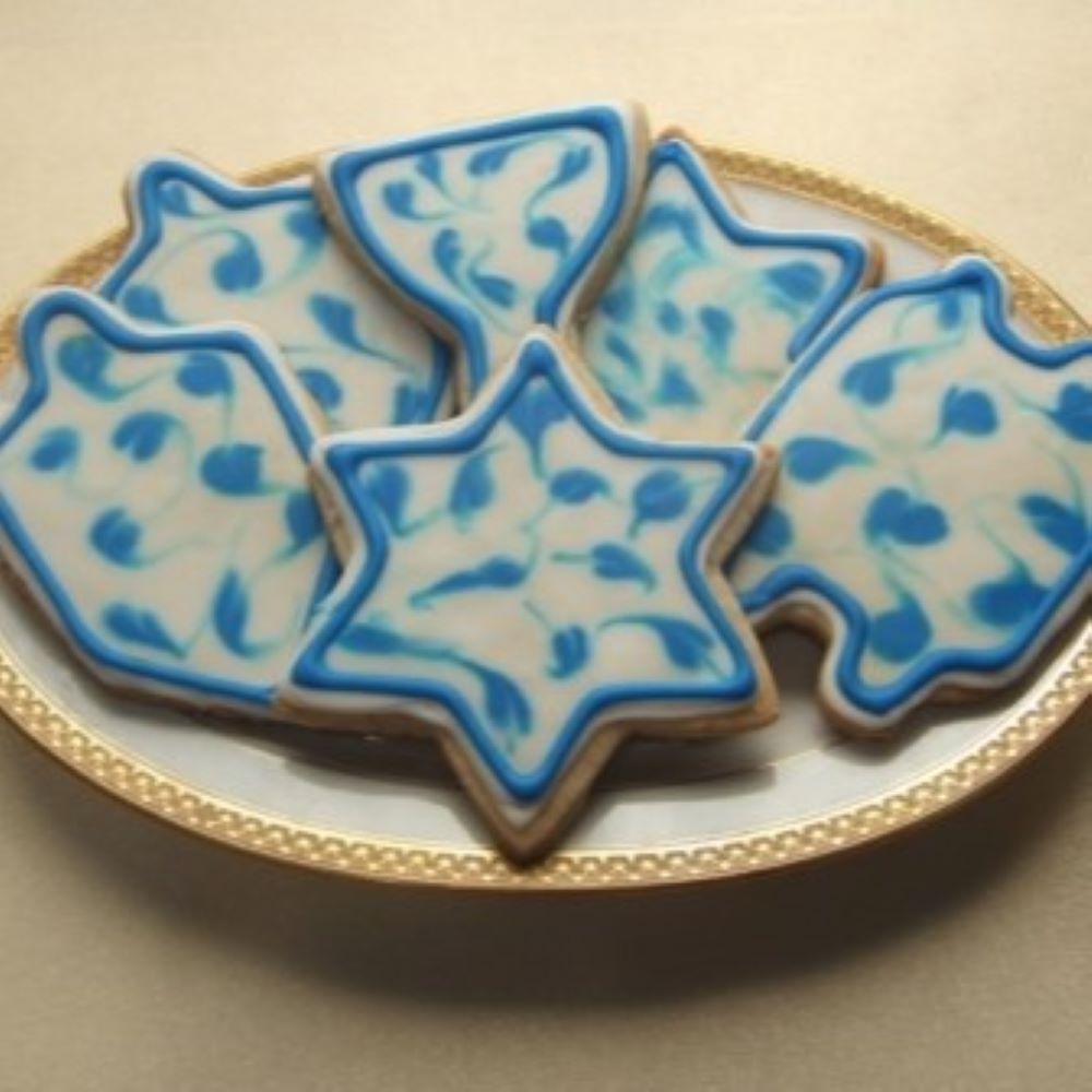 shortbread cookies shaped in various Hanukkah shapes on a plate