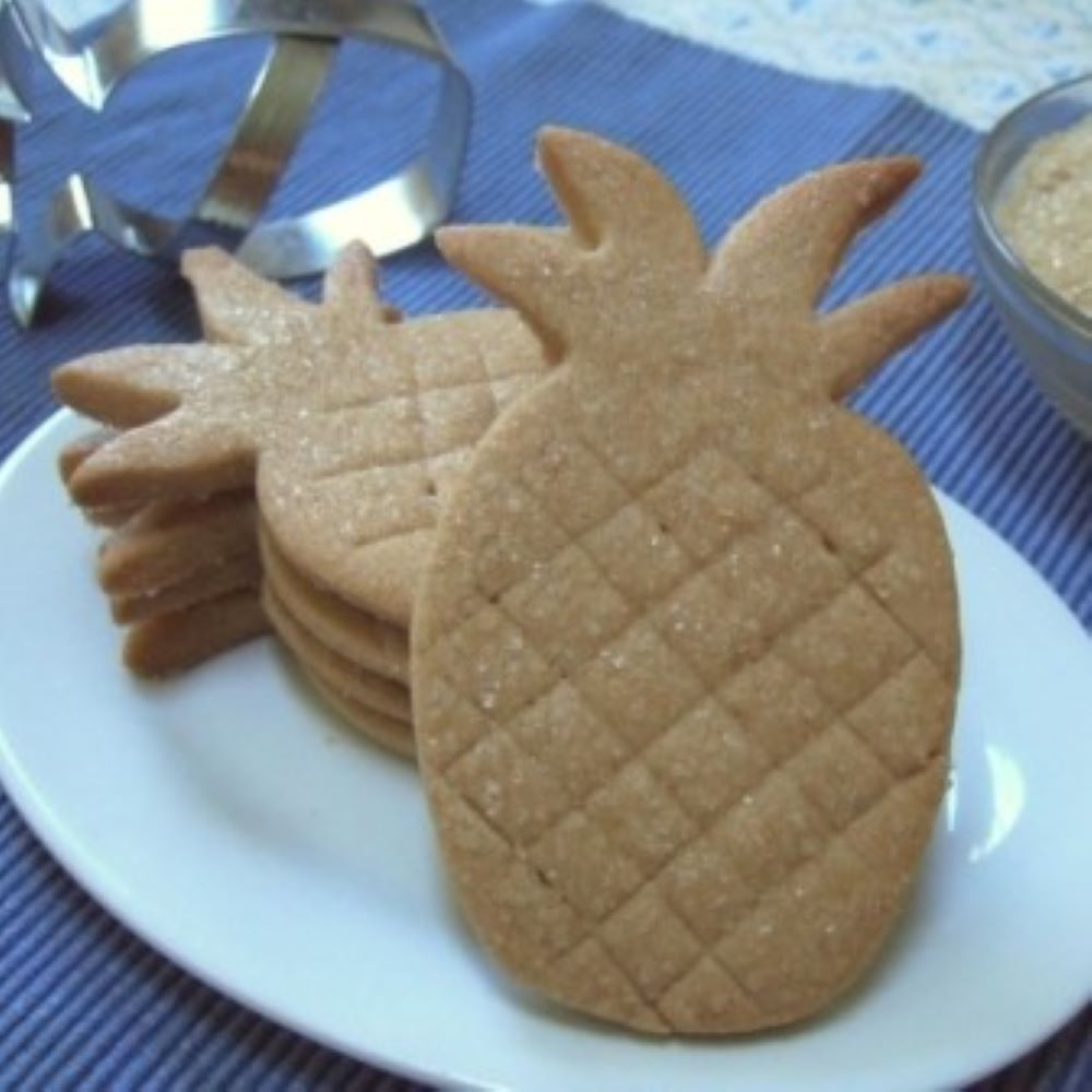 Brown sugar shortbread cookies shaped like a pineapple on a plate