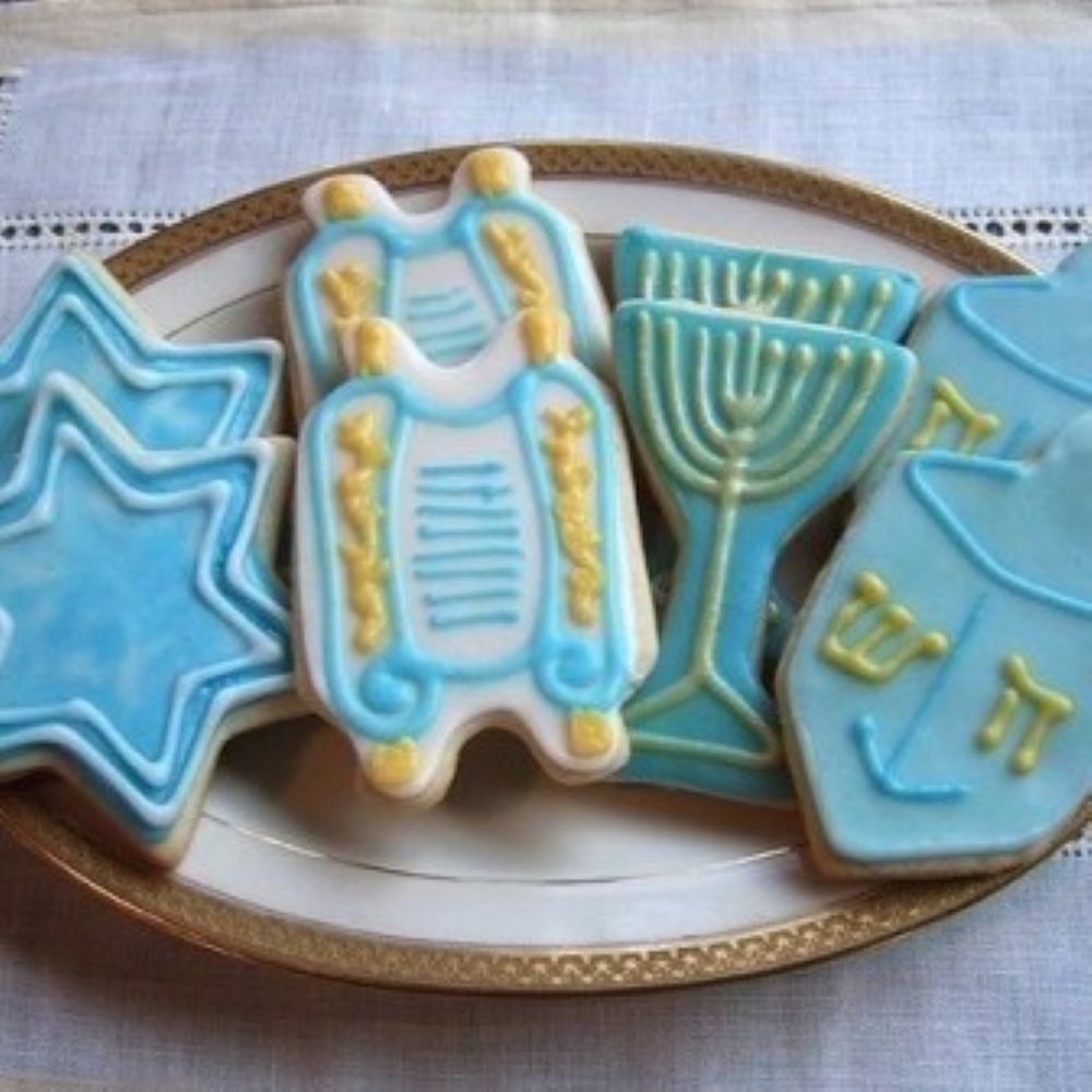 Sour cream cookies in various Hanukkah shapes on a plate