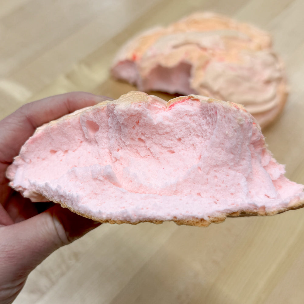 hand holding pink cloud bread slice