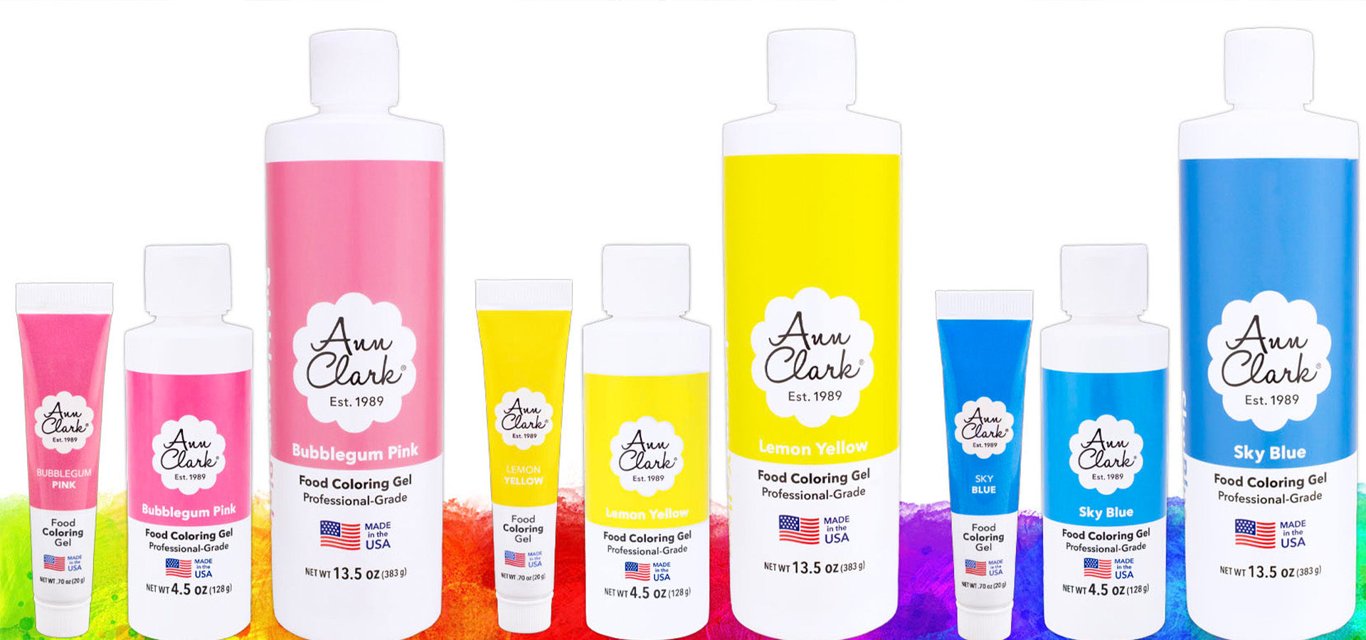 Pink, yellow, and blue Ann Clark food coloring in three sizes