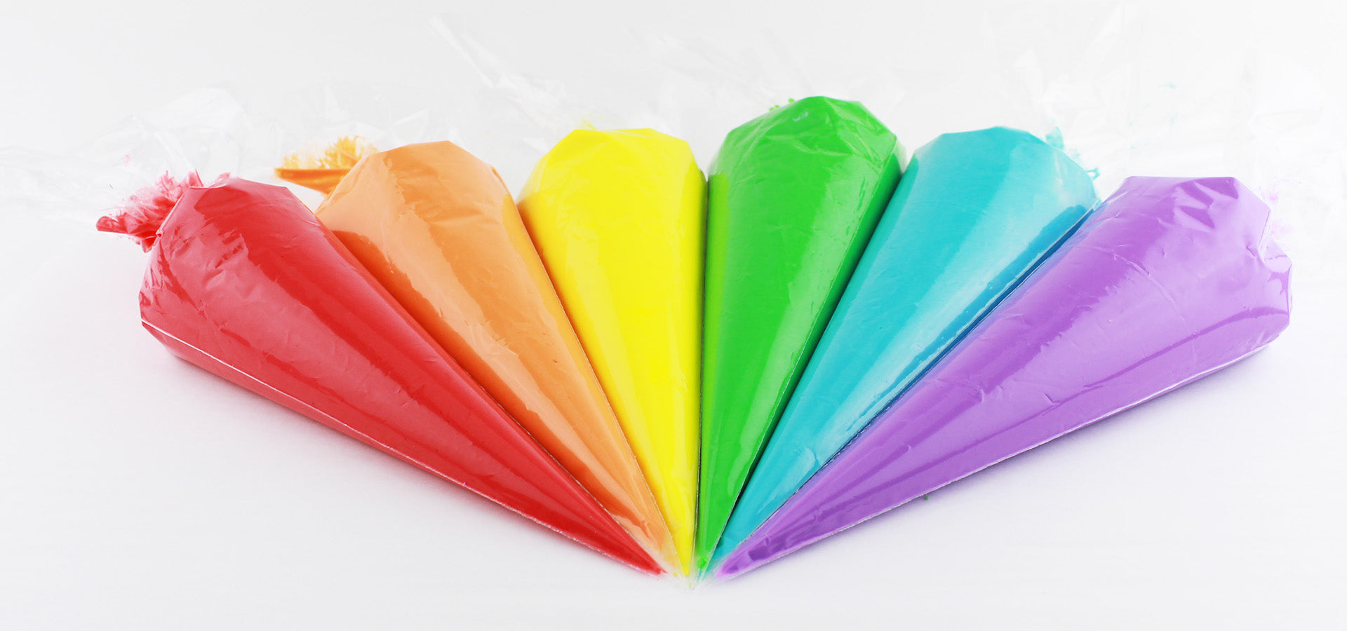 Colorful piping bags on a white countertop